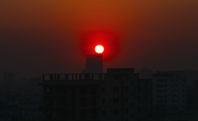 Fototapeta premium Sunset or sunrise at the city with building silhouette. Sunrise cityscape. Copy space.
