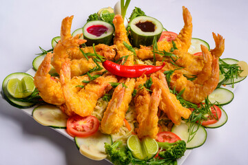 Eastern food. Fried crispy shrimp with vegetables on white background.