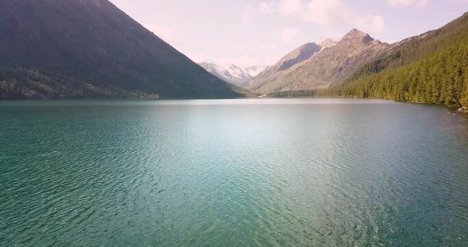 Panoramic aerial morning view of famous natural attraction of Altai and Russia - the Multa mountain lake at sunrise. National park and outdoor recreation background