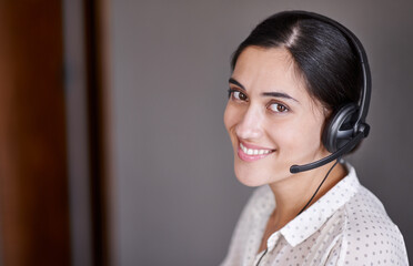 Happy to help you out. Shot of an attractive young call centre operator.