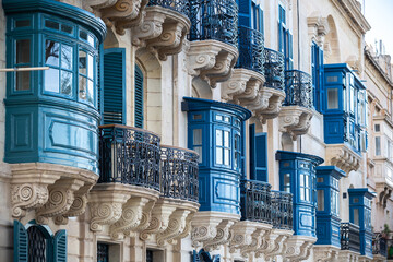 Colorful traditional balconies of Maltese in the ancient city of Valletta, Malta. Maltese residential architecture, windows 