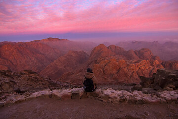 Woman tourist waiting for sunrise on the summit of the Mount Sinai (Mount Horeb, Holy Mount Moses...