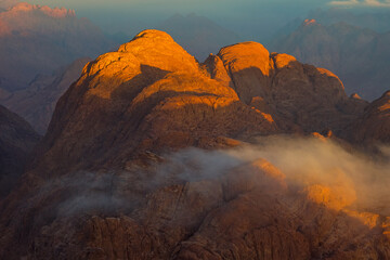 Naklejka premium Beautiful sunrise on the summit of the Mount Sinai (Mount Horeb, Holy Mount Moses or Gabal Musa), Egypt, North Africa.
