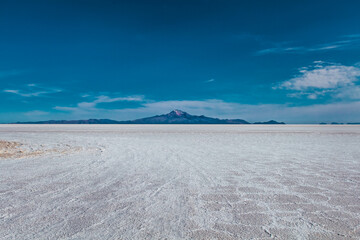 Salt desert with mountains in the background in Bolivia - Uyuni Salt Flat
