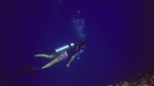underwater panoramic view of diver who swim near coral reef. Maldives