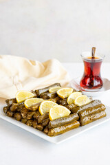 Stuffed leaves with olive oil on a white background. Traditional Turkish cuisine. Local name zeytinyagli yaprak sarma