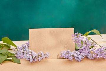 Creative vintage lilac flower with crafting paper mock up. Copy space.
