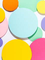 Fun bright coloured mosaic of paper circles in pink, blue, yellow and purple colours. Minimalist...