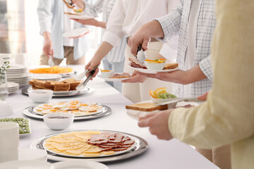 Obraz na płótnie Canvas People taking food during breakfast, closeup. Buffet service