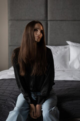 Girl with a flower in her hands. Fashion portrait with natural light