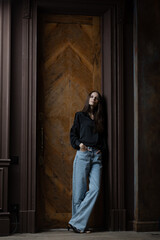 Girl with a flower in her hands. Fashion portrait with natural light