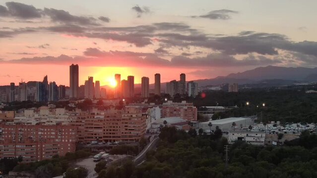Aerial drone panoramic sunset view of Benidorm skyline skyscrapers hotels and resorts, Benidorm seaside coastline Spain Alicante 
