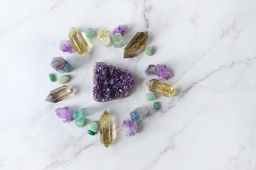 Fototapeta na wymiar different crystal gemstones on marble background. Minerals set for healing esoteric ritual, spiritual Magic practice, relaxation and meditation. life balance concept. flat lay