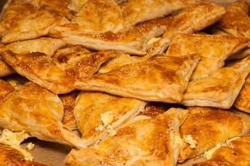 Puffs with cheese and sesame seeds. Ready, baked puff pastries for cheese and sesame seeds.