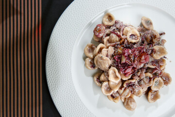 piatto di orecchiette condite servito su un piatto bianco 