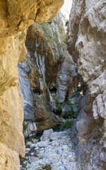 Tourist route with tunnels excavated in the rock parallel to the Cares River (Ruta del Cares). Gorge in the Picos de Europa between Asturias and Leon. Spain 