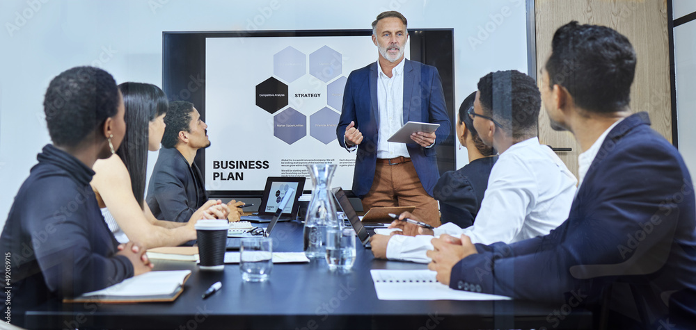 Poster running through some highlights of the topic. shot of a mature businessman using a digital tablet du