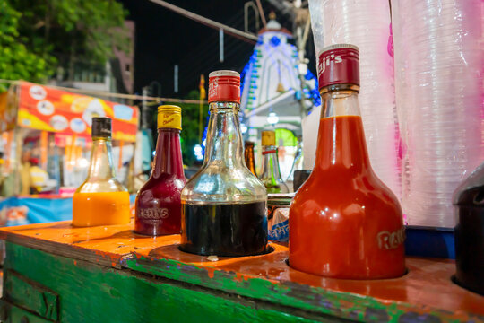 Howrah, West Bengal, India- April 14th 2019 : Colourful juices and syrups for making ice gold or Barf ka gola or chuski or gola ganda, a summer delicacy made of crushed ice, Indian street food.