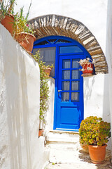 the old and solid painted wooden doors are one of the charms of the magnificent Cyclades islands, in the heart of the Aegean Sea