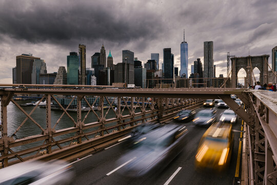 Fast cars driving on bridge in megapolis in cloudy day