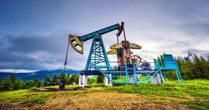 Rapid movement of clouds over a classic oil gas pump in the carpathians Ukraine in time-lapse technique vide. An ancient hydrocarbon deposit in Europe, more than a hundred years old.