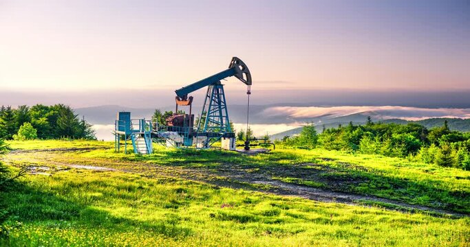 Rapid movement of clouds over a classic oil gas pump in the carpathians Ukraine in time-lapse technique vide. An ancient hydrocarbon deposit in Europe, more than a hundred years old.