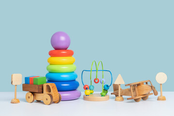 Educational toys for preschool children. Wooden and plastic toys on a blue background. Copy space