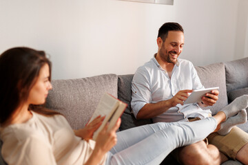 Couple reading at home in the morning