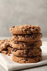 Delicious chocolate chip cookies on light grey table