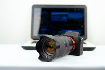 Digital photography workstation. Modern DSLR digital camera,laptop and screen.