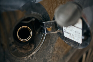 Close-up of opened petrol cap of car at gas station.