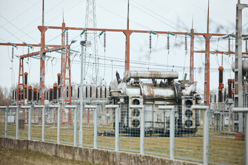 Fototapeta na wymiar Rusty electricity substation and high voltage transformers.