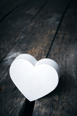 Fototapeta premium White heart in crack on old wooden floor.