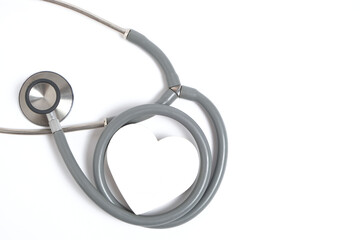 White heart and stethoscope on white background.Heart disease, medical examination.