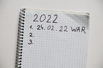 Notepad with the text of the year 2021 and 2022. Plans for the year 2022 war in Ukraine. All forces...