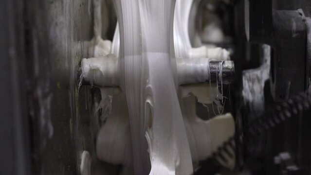 Video of making white gum in the gumball machine in the gum factory. Clear and close video of the white gum production stages