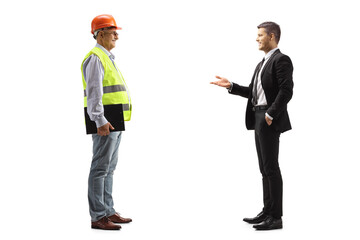 Young businessman talking to a mature engineer