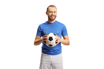 Football player in a blue jersey and white shorts holding a ball and smiling