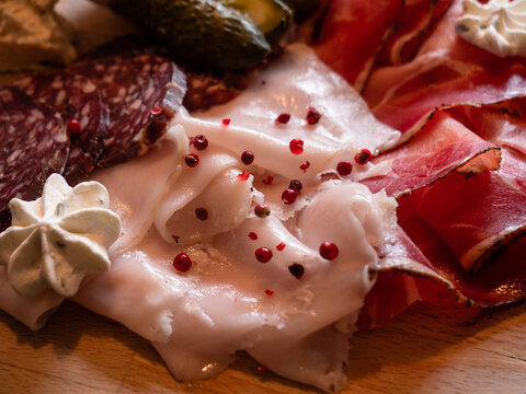 Lardo Pork Fat, Speck and Salami Mixed Cold Cuts on a Board in Cortina d'Ampezzo, Italy, the Tagliere of Affetati Misti are a Speciality of the Dolomite Mountain Cuisine