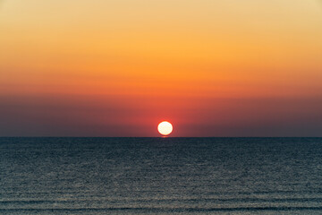 The sun rising over the horizon