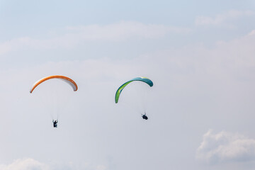 Paraplaners with beautiful blue sky and clounds in the background
