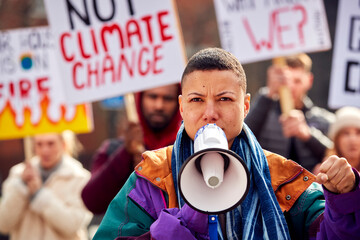 Group Of Protestors With Placards On Demonstration March Against Climate Chane