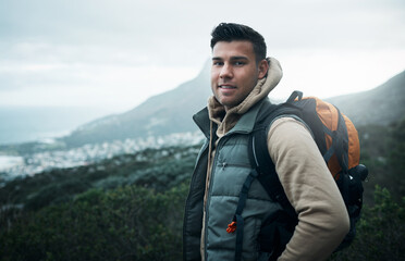 It feels good to be lost in the right direction. Portrait of a young man hiking through the...