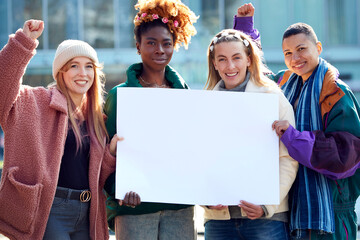 Portrait Of Female Protestors Holding Blank Placard On Demonstration March