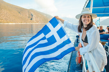 woman with greece flag at cruise boat lefkada island