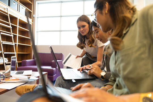 Creative businesswomen using laptops in office