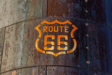 Fototapeten Weathered stained Route 66 emblem marker on the side of a large very rusty tank on Route 66 in Arizona. © Wayne Stadler Photo