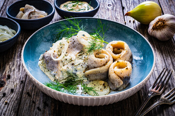 Swedish style marinated herring fillets in mayonnaise and cream with pickled cucumber, parsley,...