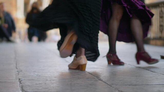 Spanish traditional flamenco dancers in the street, female flamenco artists dancing in Seville, feet of street flamenco dancers in Andalusia, Spain