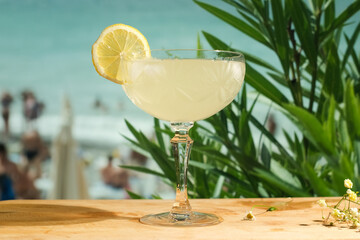Glass of gimlet cocktail. Beach bar, summer sea resort concept.